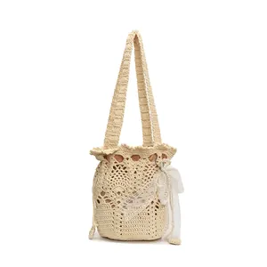 Elegant ivory crochet bucket bag with hollow knit patterns and pearl lace bow details