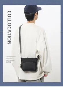 Rear view of a black nylon crossbody chest bag on model showcasing adjustable shoulder straps