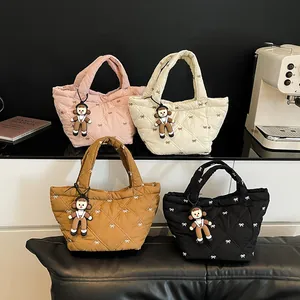 Quilted bucket bags in four colors with diamond patterns and delicate bow embroidery