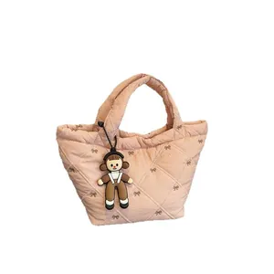 Pink quilted bucket bag with bow details and cute cartoon charm for women