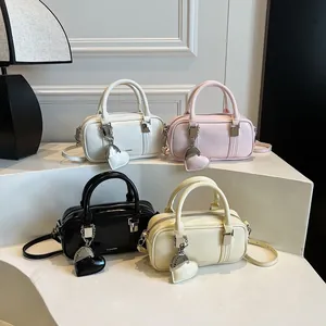 Chic women's leather Boston bags in four colors with heart charm and detachable strap