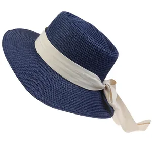 Navy blue straw boater hat featuring a cream herringbone ribbon and elegant side bow