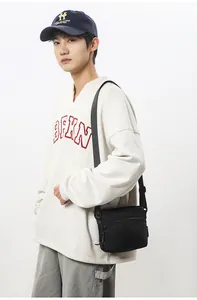 Close-up of durable black nylon crossbody bag with adjustable strap and zipper detail