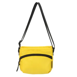 Yellow nylon crossbody chest bag with adjustable black strap shown on white background