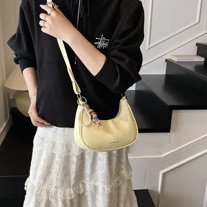 French style creamy yellow underarm baguette bag with pearl chain and doll pendant