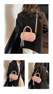 Macro detail of a pink bowling-style pillow bag featuring lychee grain leather texture