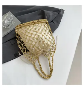 Detail der goldmetallischen Netztasche mit beigefarbenem Satin-Kordelzugbeutel und Griff