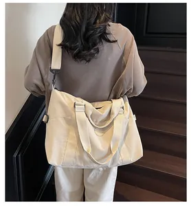 Canvas travel tote with adjustable strap and side pockets shown in a lifestyle indoor setting