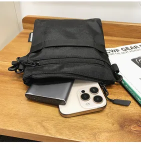 Detail showing the large capacity of this black nylon crossbody bag for digital storage