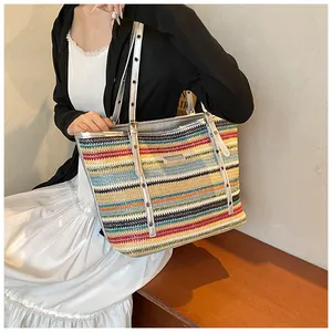 Close-up of multicolor woven tote with silver metallic grommet straps and texture