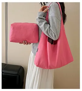 Rose red canvas tote bag and matching zipper pouch set shown in a lifestyle indoor setting