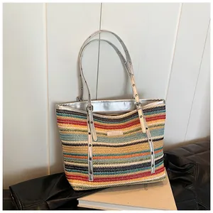 Detail of colorful striped woven tote bag with silver metallic straps and bohemian texture