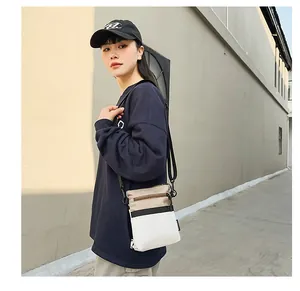 Detailed side view of nylon crossbody bag featuring stylish color-block panels and strap