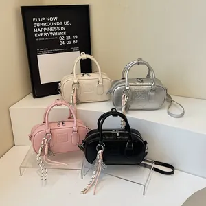 Retro bowling handbag in four colors with double handles and tennis racket charm detail