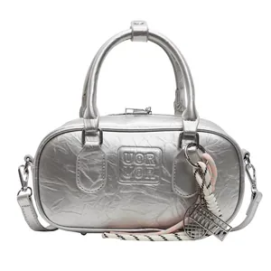Silver metallic bowling handbag with UOR UOR embossed logo and unique charms