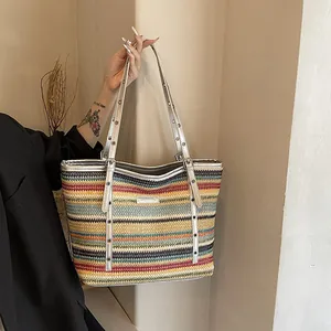 Colorful striped woven tote bag with silver metallic straps for beach vacations
