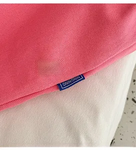 Detail of pink canvas tote showing diagonal twill texture and NING NING label stitching