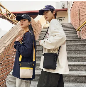 Detail of waterproof nylon crossbody bags in tricolor patchwork and black with zipper