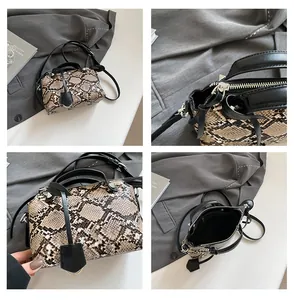 Close-up of snakeskin pattern handbag showing silver hardware and interior lining