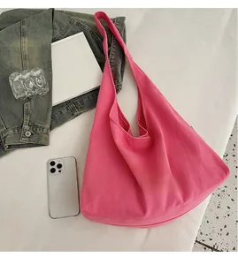 Spacious rose red canvas tote bag shown with daily essentials like a phone and book