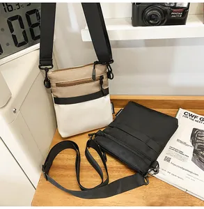 Close-up of casual nylon crossbody bags with metal hardware and multi-zipper detail