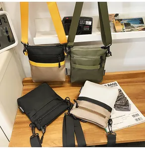 Detail of multi-color nylon messenger bags with adjustable straps on wooden desk