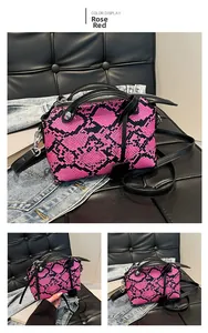 Detailed macro view of rose red snakeskin texture leather handbag with silver rivets