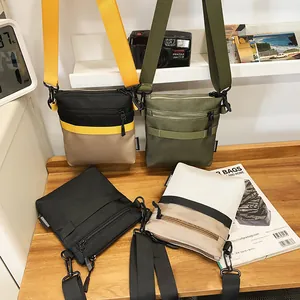Outdoor crossbody bag in nylon with patchwork design and wide adjustable strap