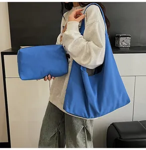 Detail of royal blue canvas tote and clutch set showing thick woven texture and strap