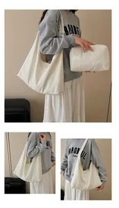 Detail of minimalist cream canvas hobo tote bag and matching zippered pouch set