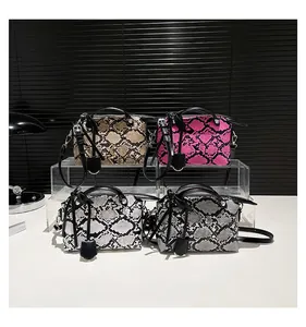 Detailed set of four snakeskin pattern handbags in beige, pink, white, and grey finishes
