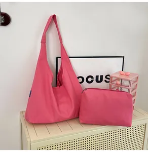 Detail of bright pink canvas tote bag and matching small zipper pouch on a storage shelf