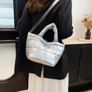 Metallic silver quilted down handbag for women with adjustable strap and puffy nylon texture