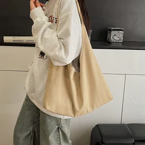 Minimalist beige canvas tote bag with wide shoulder straps for casual large capacity use