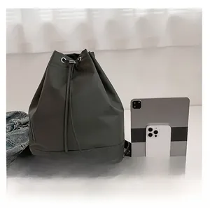 Detailansicht grauer Kordelzug-Rucksack mit Kapazitätsvergleich für Tablet und Handy