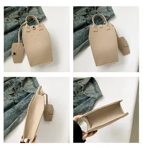 Detail view of beige coffin shaped gothic crossbody bag with embossed cross pattern