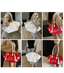 Detail view of large nylon tote bags with script printing and sturdy white handles