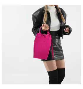 Detail of pink coffin-shaped gothic tote bag with cross embroidery and felt texture