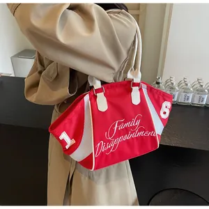 Detail of red canvas tote bag with white mesh stitching and embroidered number patch