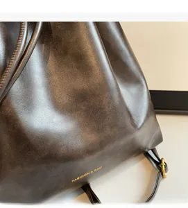 Macro detail of dark brown leather texture with gold Fashion & Bag lettering