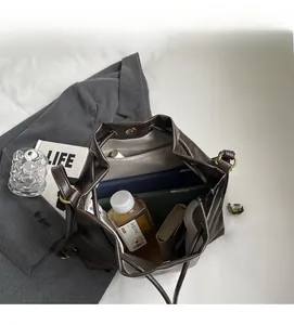 Top view of open bucket bag interior showing spacious storage for tablet and wallet