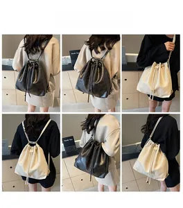 Detail view of the versatile bucket bag shown in black and beige being worn in various styles