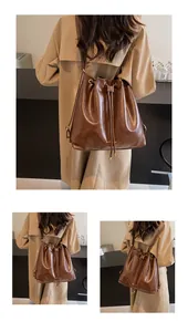 Detailed view of the large capacity brown bucket bag with drawstring and metal buckles