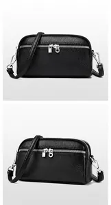 Détail du sac bandoulière en cuir grainé noir avec double fermeture éclair argentée