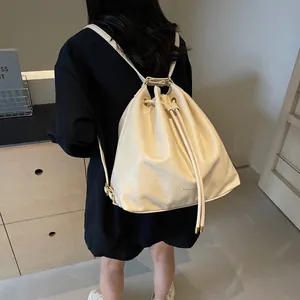 Fashionable creamy white bucket backpack with drawstring and adjustable thin straps