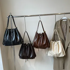 Large bucket backpack in black dark brown brown and beige colors with drawstring closure