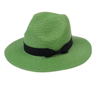Grass green Panama straw hat for women with a black ribbon bow and fine weave texture