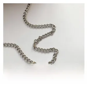 Detail view of the silver oval link metal chain strap with polished metallic finish
