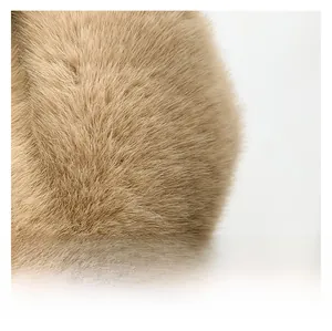 Macro shot of soft khaki faux fur material showing the plush texture of the bucket bag