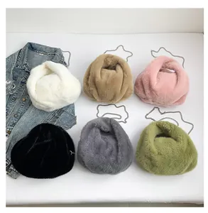 Flat lay of soft faux fur crossbody bucket bags in six colors with silver chain straps
